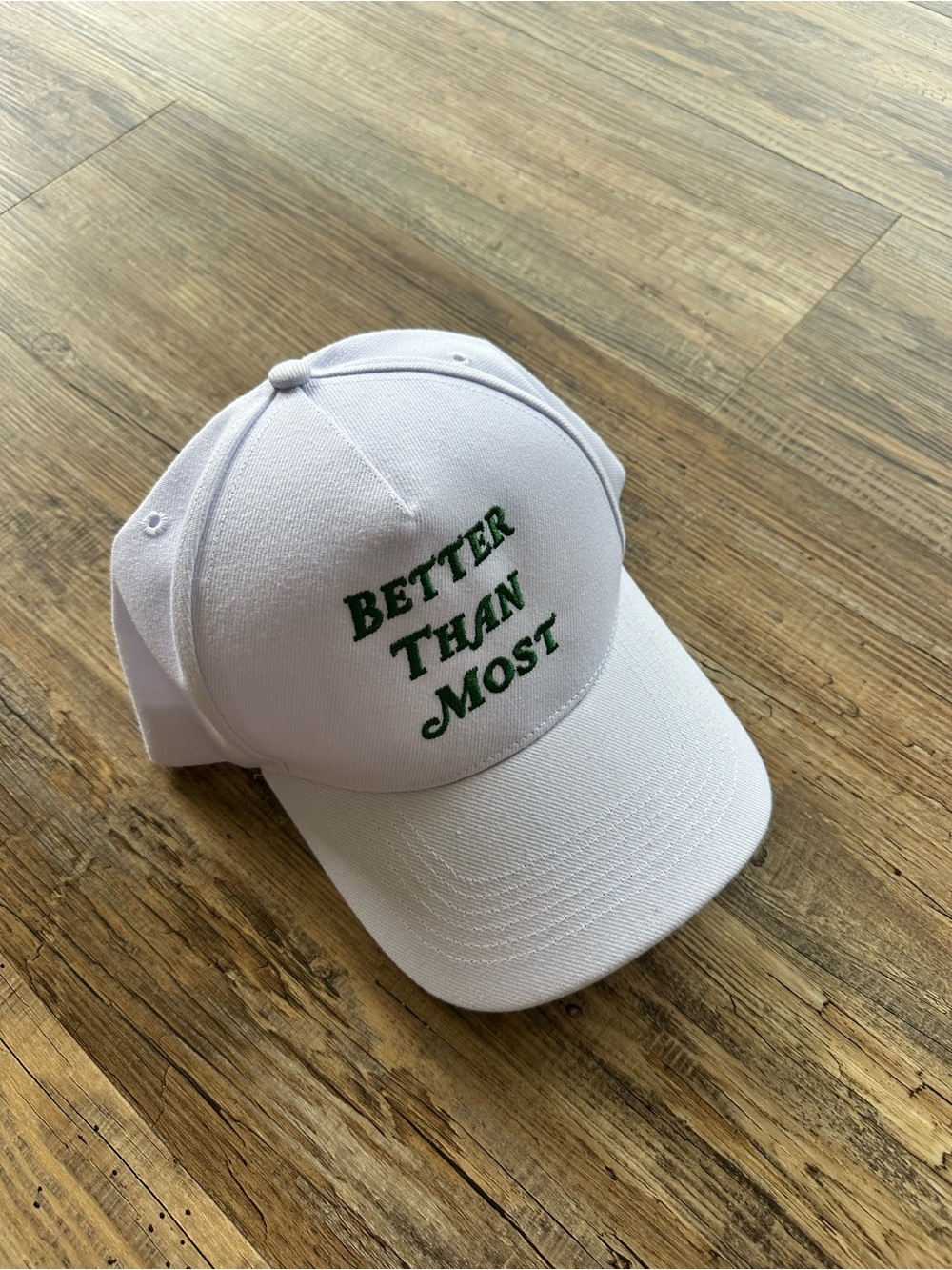 White Baseball Cap with Green "Better Than Most" Embroidery